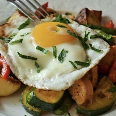 Poached egg on top of assorted roasted vegetables