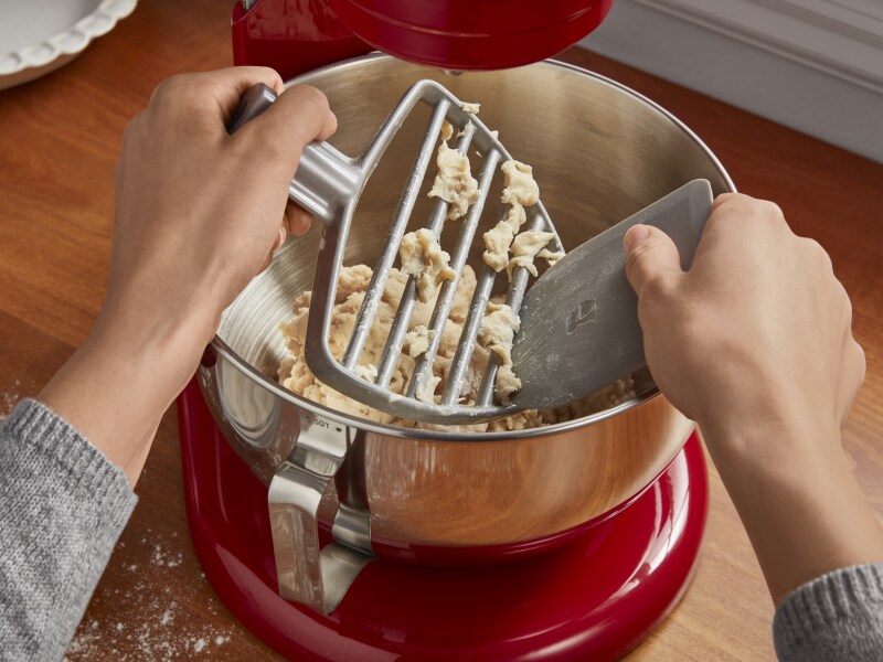 Dough being removed from a pastry beater Dough being removed from a pastry beater