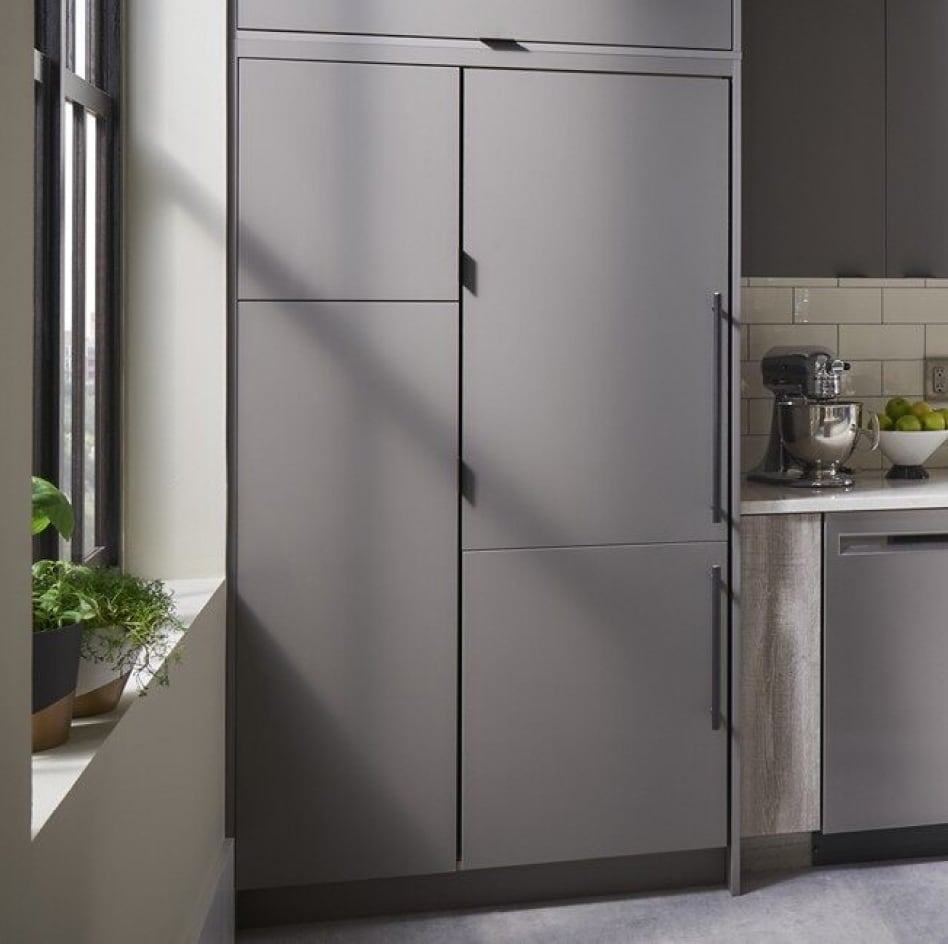 Minimal kitchen with gray cabinets and panel-ready refrigerator Minimal kitchen with gray cabinets and panel-ready refrigerator
