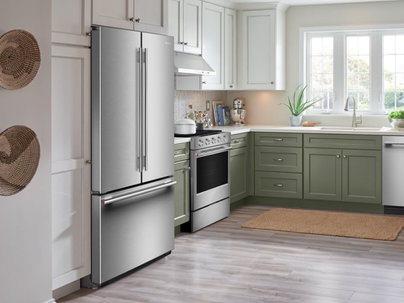 A stainless steel freestanding refrigerator in a kitchen