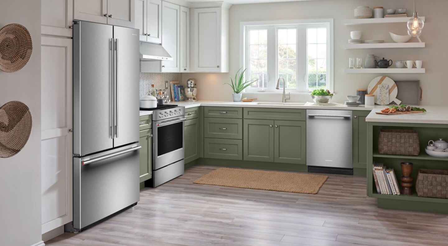 A stainless steel freestanding refrigerator in a kitchen
