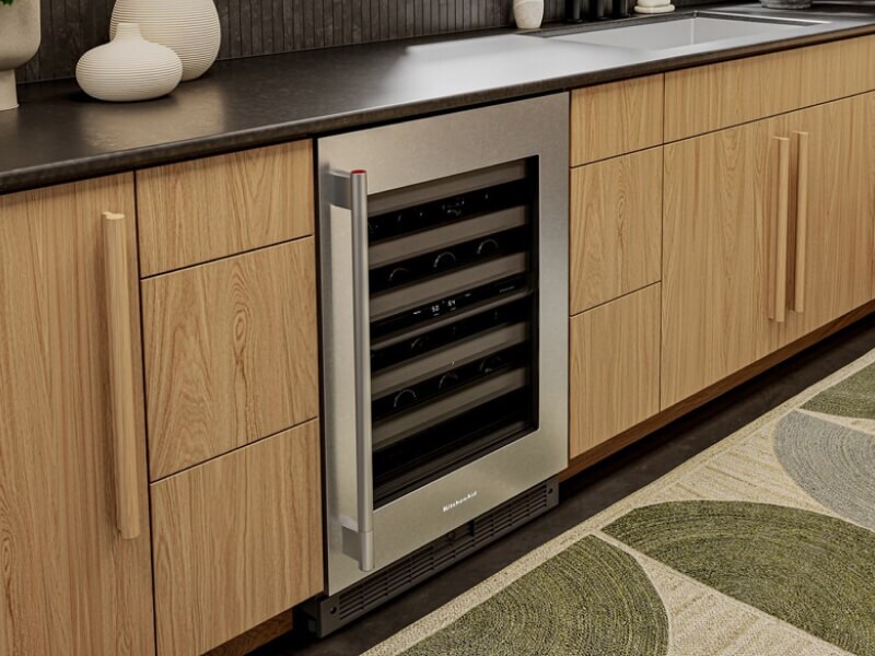 An undercounter refrigerator with wine bottles inside