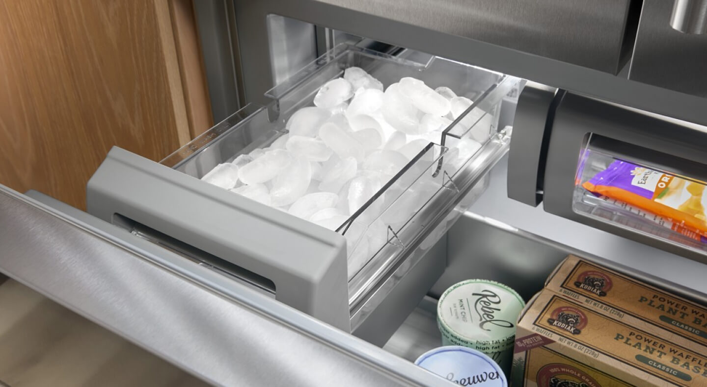 A pull-out ice drawer in a freezer