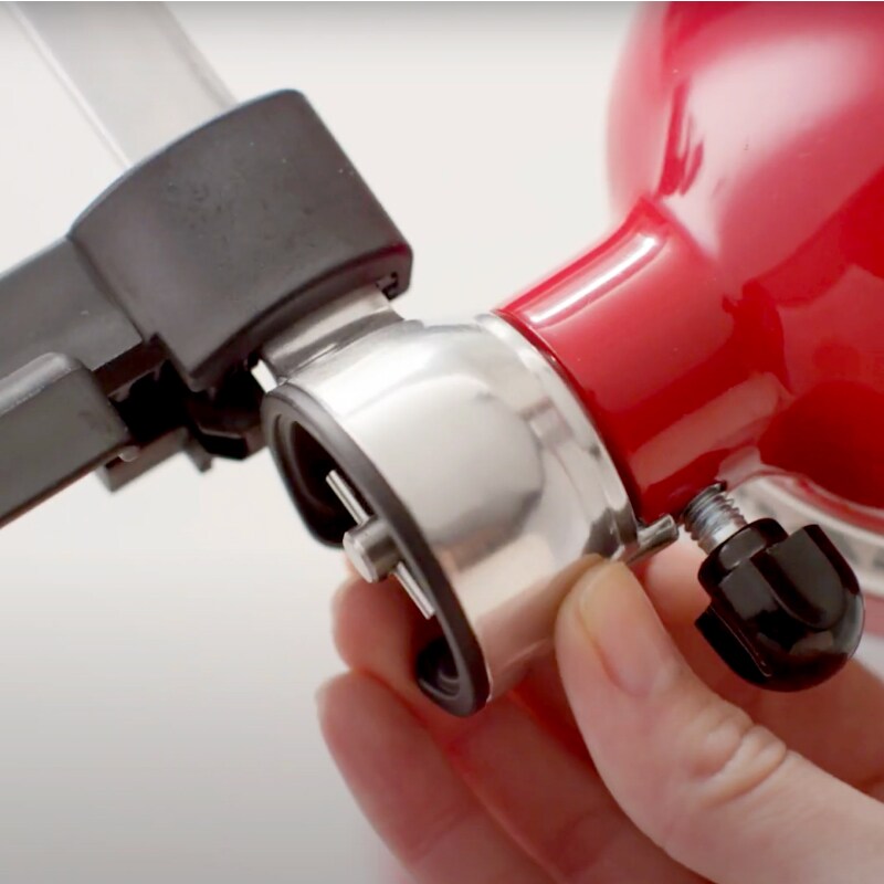 Hands moving the Vegetable Sheet Cutter blade carrier into the locked position