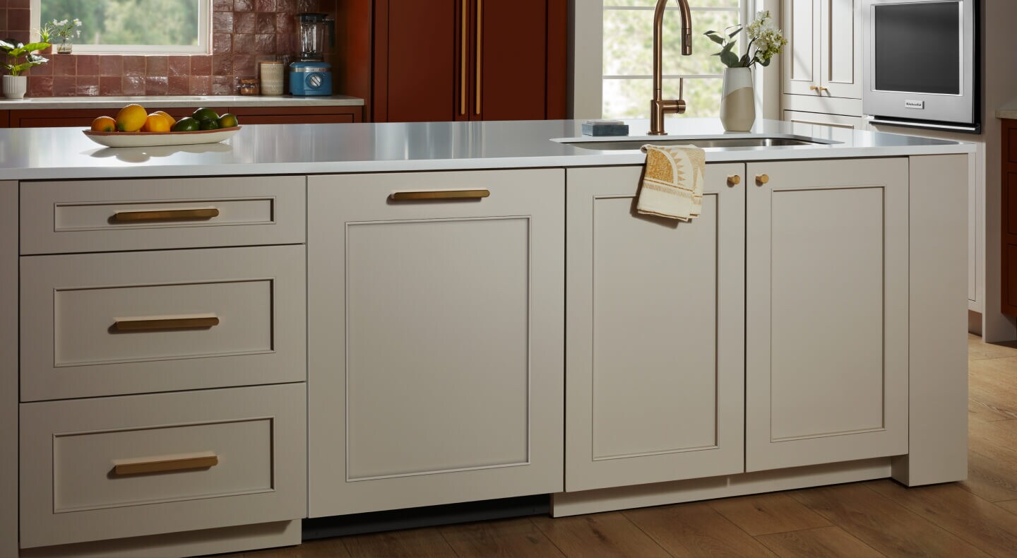 A KitchenAid® panel-ready dishwasher in a kitchen with light cabinets