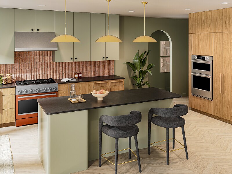 A commercial-style range shown in a kitchen with wood and sage green cabinetry