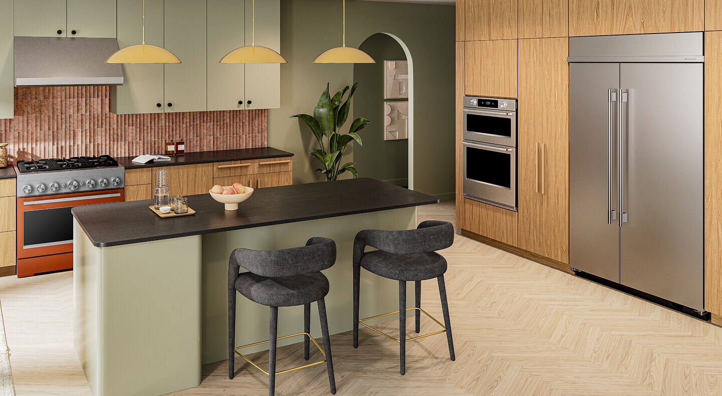 A commercial-style range shown in a kitchen with wood and sage green cabinetry
