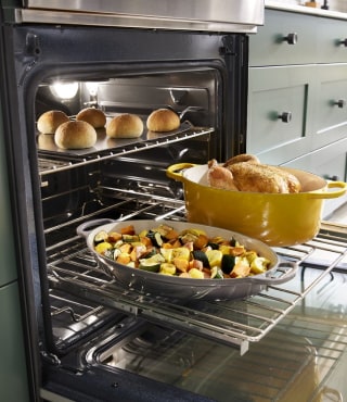 Multiple food items on the rack of a KitchenAid® range