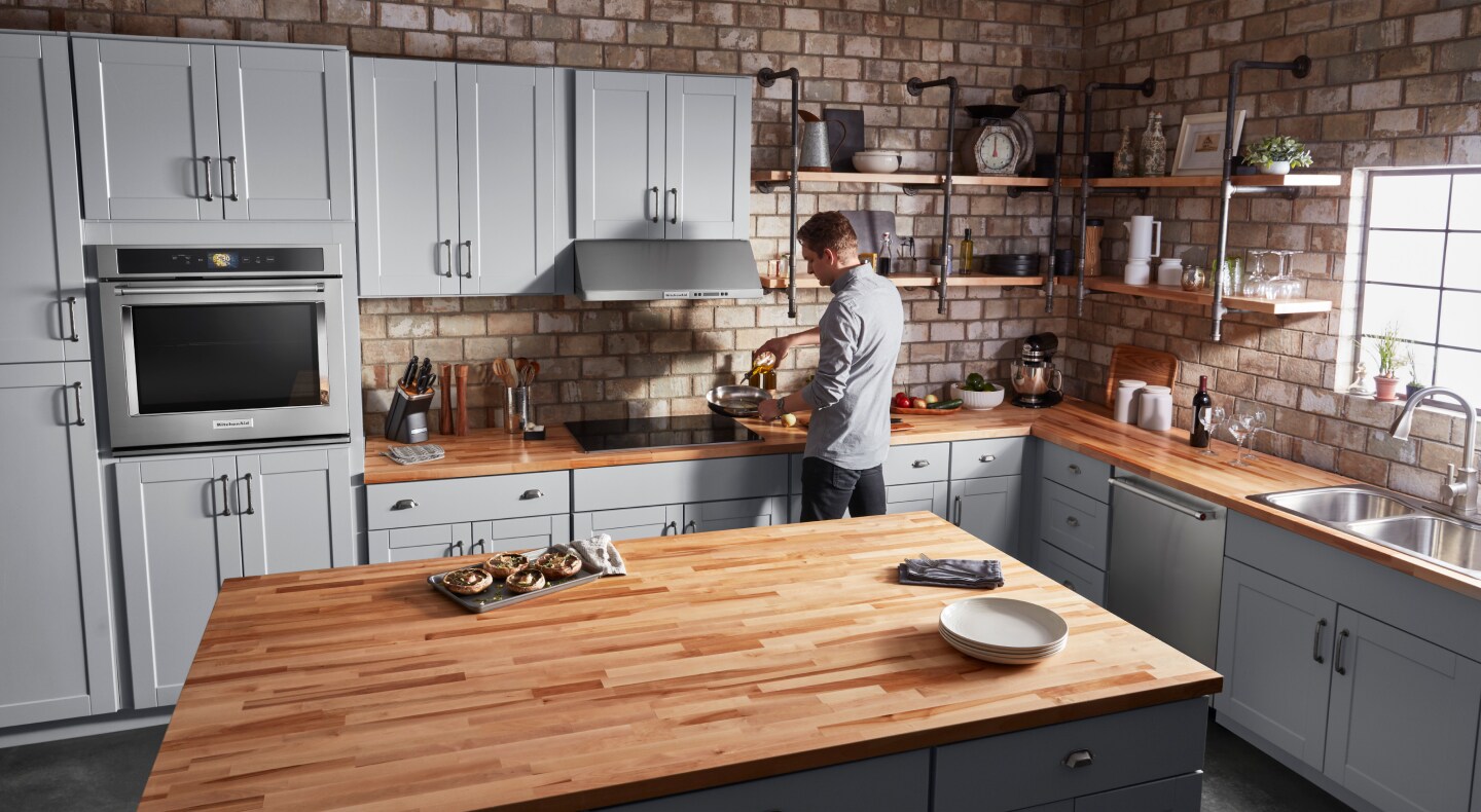 A man preparing a recipe in a modern kitchen setting A man preparing a recipe in a modern kitchen setting