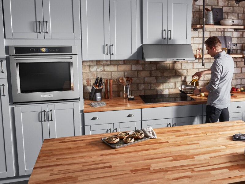 A man preparing a recipe in a modern kitchen setting A man preparing a recipe in a modern kitchen setting