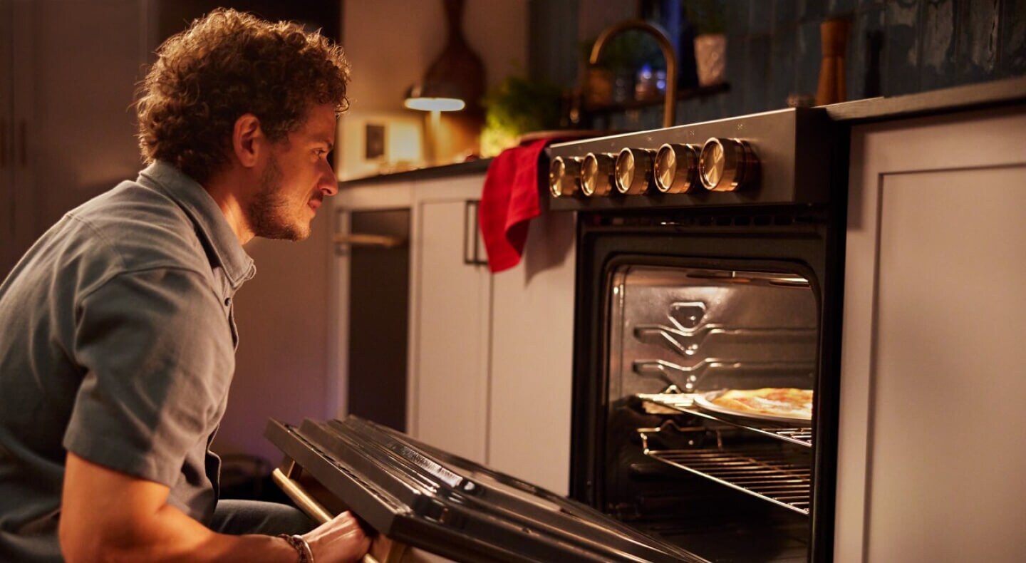 Person opening an oven to check on food
