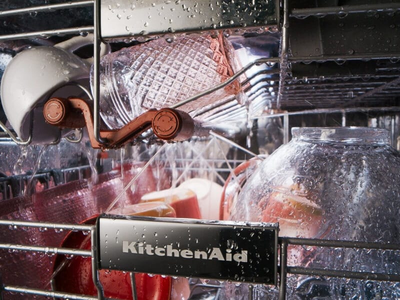 Dishes rinsing on the top and third racks of a KitchenAid® dishwasher