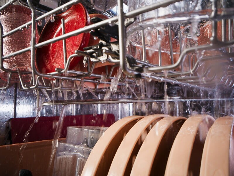 Close-up of dishes rinsing in the dishwasher