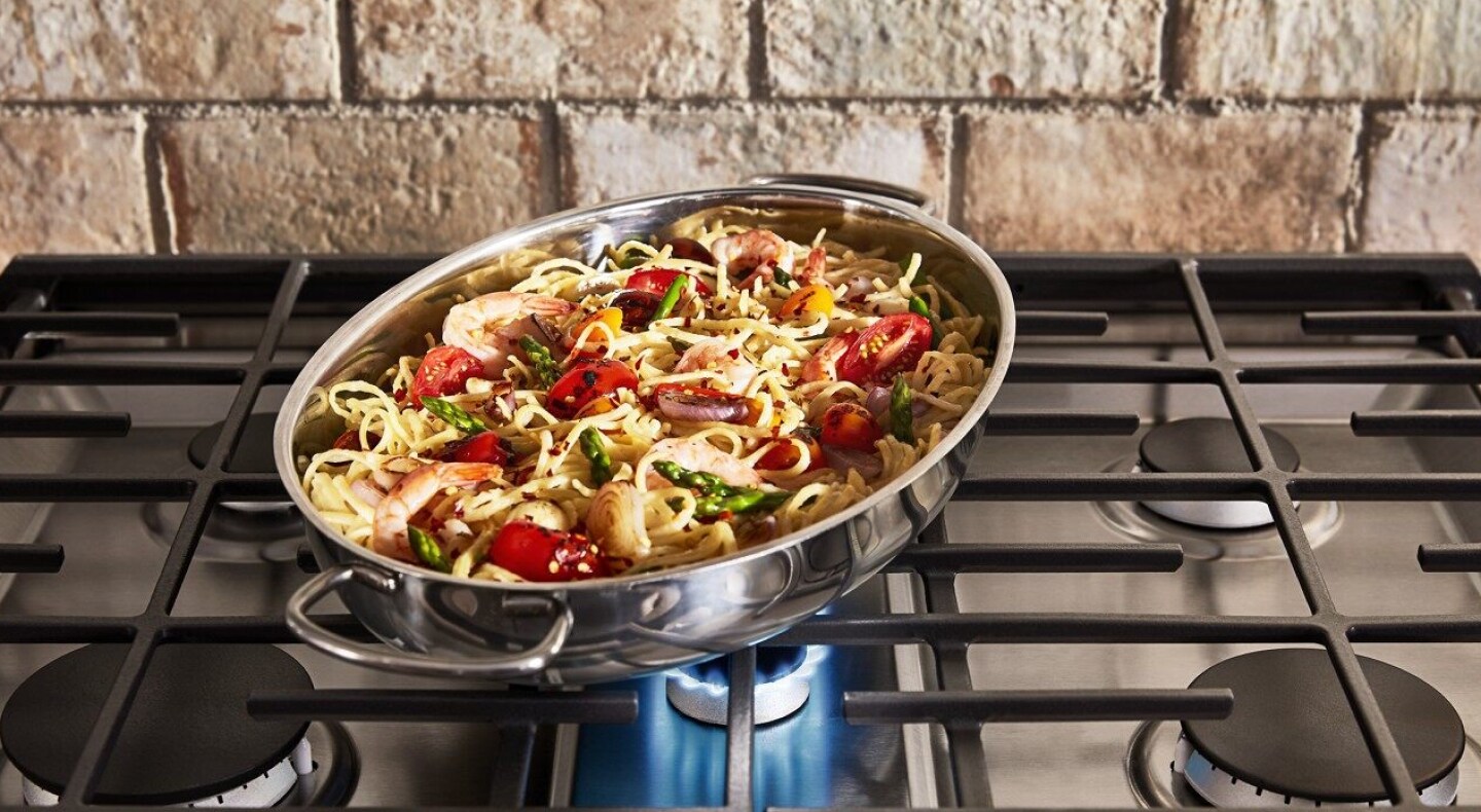 Pasta and vegetables in a pan on a range Pasta and vegetables in a pan on a range