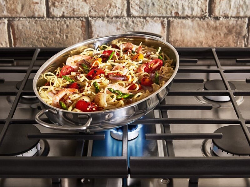 Pasta and vegetables in a pan on a range Pasta and vegetables in a pan on a range