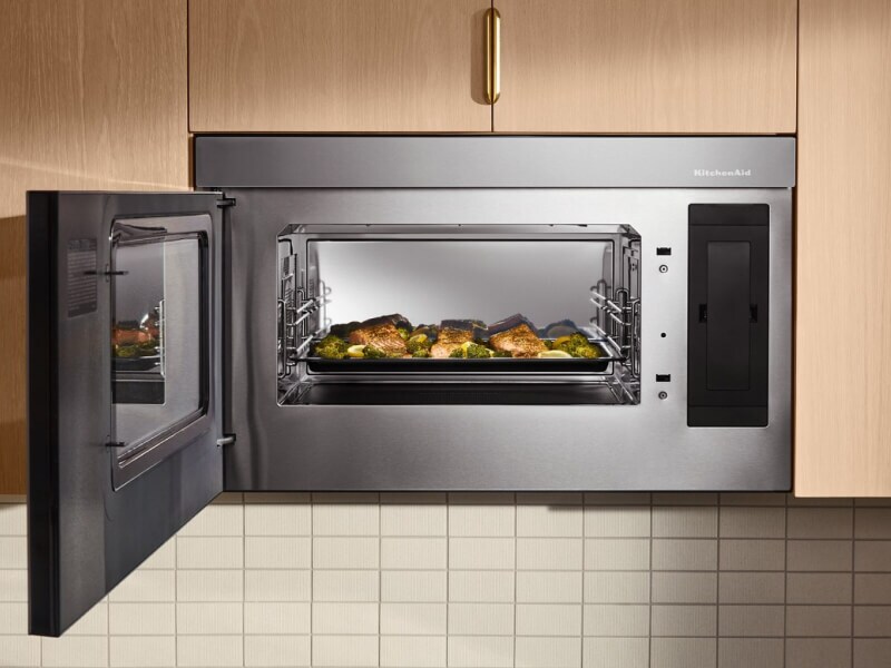 An open KitchenAid® microwave with a dish inside An open KitchenAid® microwave with a dish inside