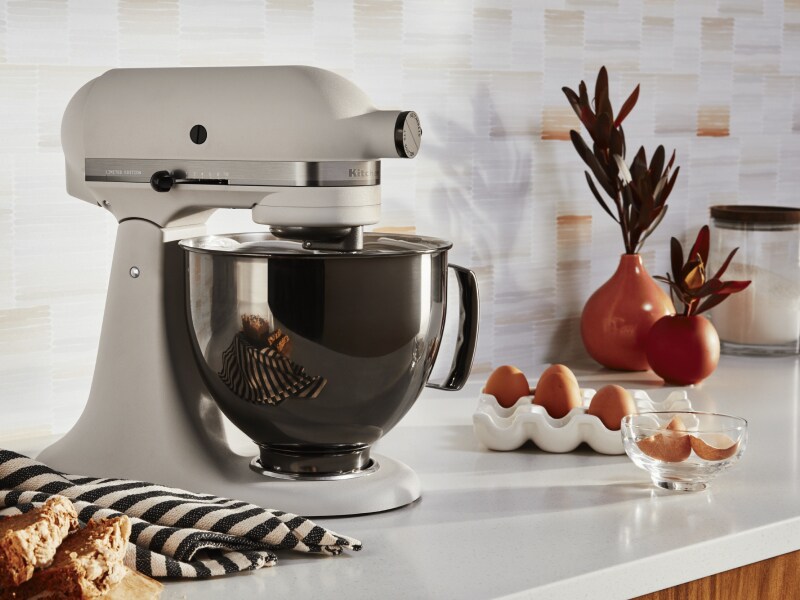 A KitchenAid® stand mixer next to eggs in a modern kitchen.