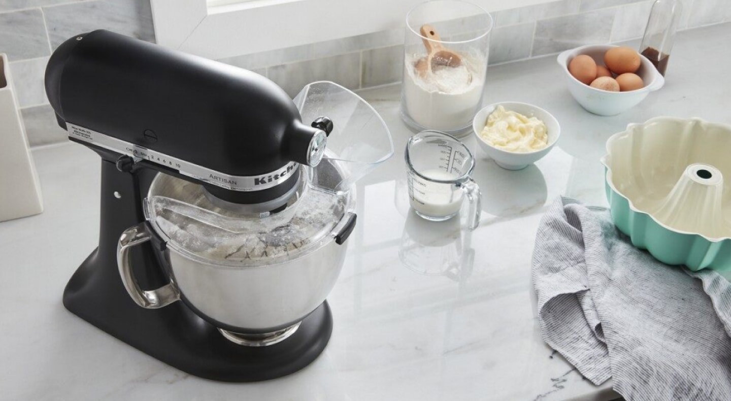 A black KitchenAid® stand mixer and various kitchen items on a countertop  A black KitchenAid® stand mixer and various kitchen items on a countertop