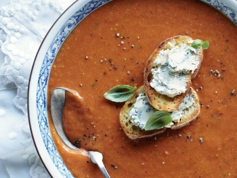 Birds-eye view of roasted tomato soup garnished with melba toast slices