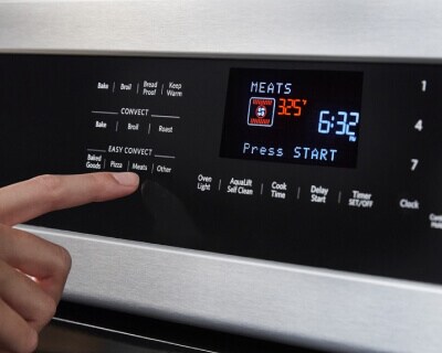 A person setting a convection temperature setting on their KitchenAid® range