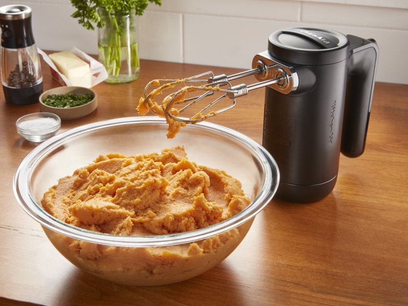 KitchenAid® hand mixer with bowl of pureed sweet potatoes