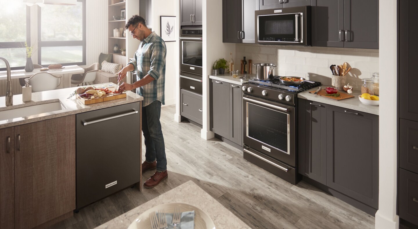 Person cutting vegetables at a kitchen island Person cutting vegetables at a kitchen island