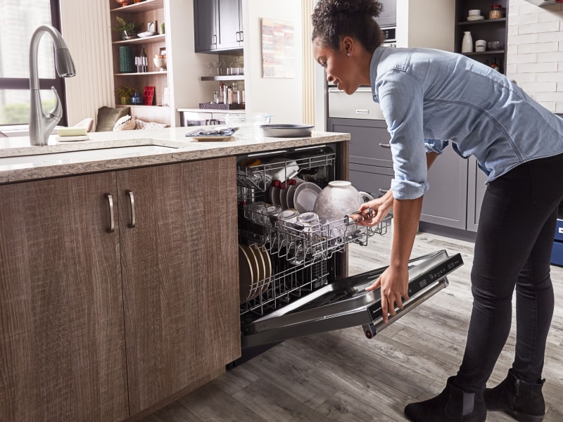 Person closing dishwasher door Person closing dishwasher door