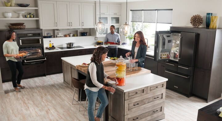 Group of people in an open concept kitchen Group of people in an open concept kitchen