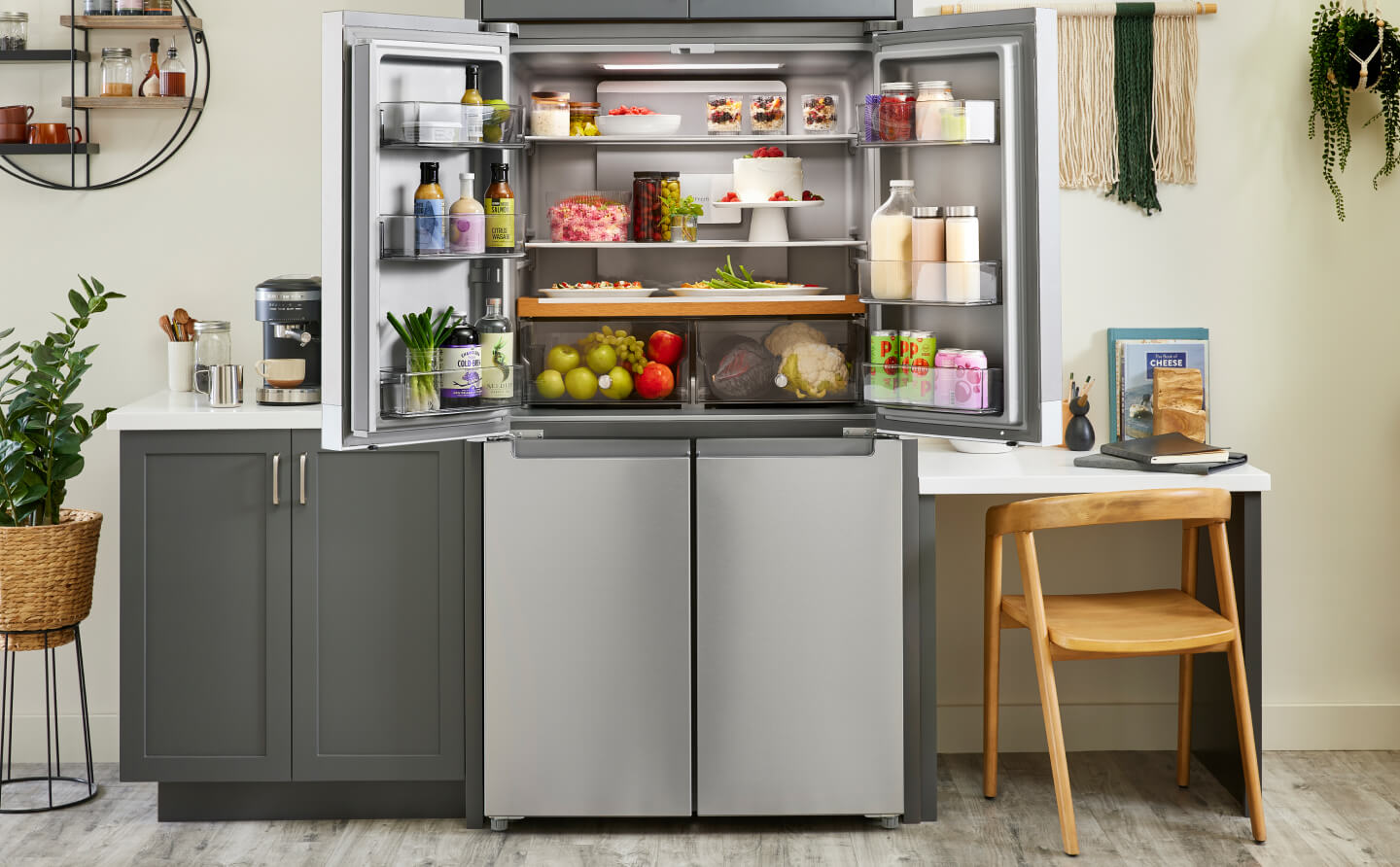A 4-door refrigerator with the top doors opened to reveal a fully stocked interior