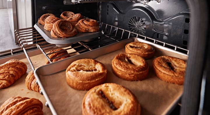 Baked goods on the inside of an oven Baked goods on the inside of an oven