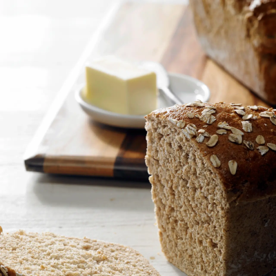 Multigrain bread next to a butter dish