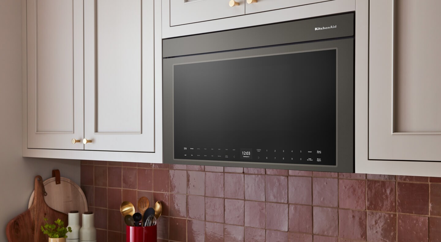 KitchenAid® over-the-range microwave built into cream-colored cabinetry