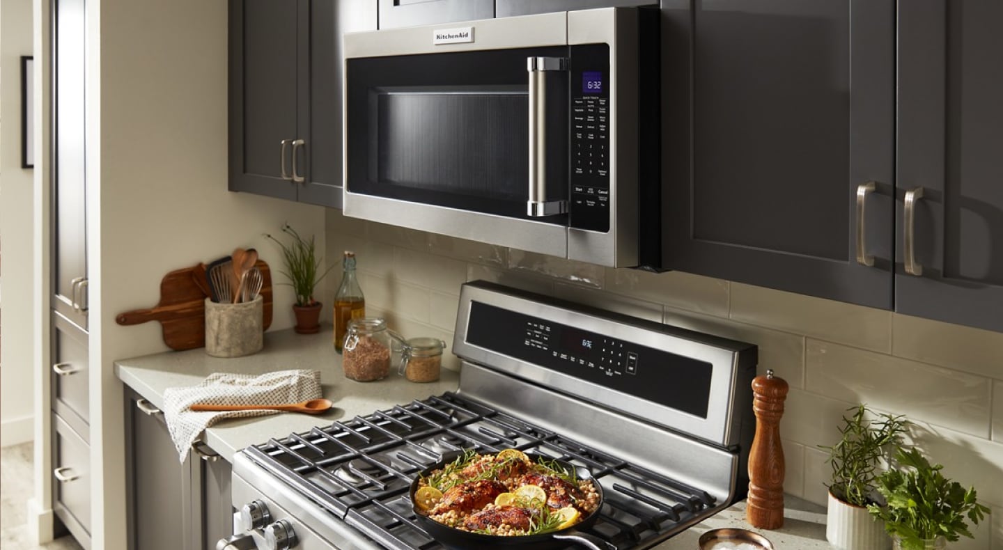 KitchenAid® stainless over-the-range microwave above a KitchenAid® gas range KitchenAid® stainless over-the-range microwave above a KitchenAid® gas range