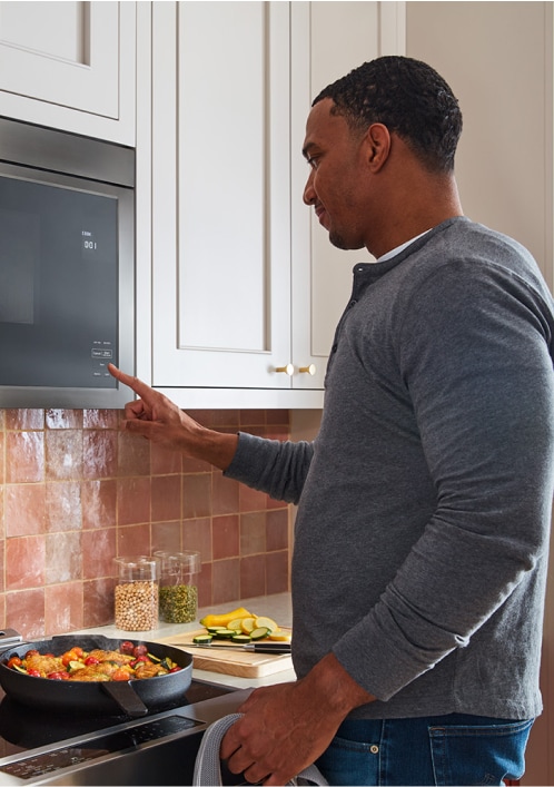 Man using KitchenAid microwave