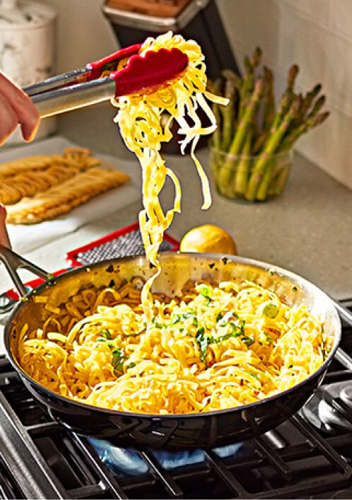 Person cooking on KitchenAId cooktop
