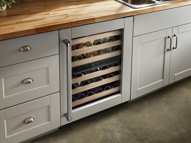 Undercounter refrigerator set in gray cabinetry