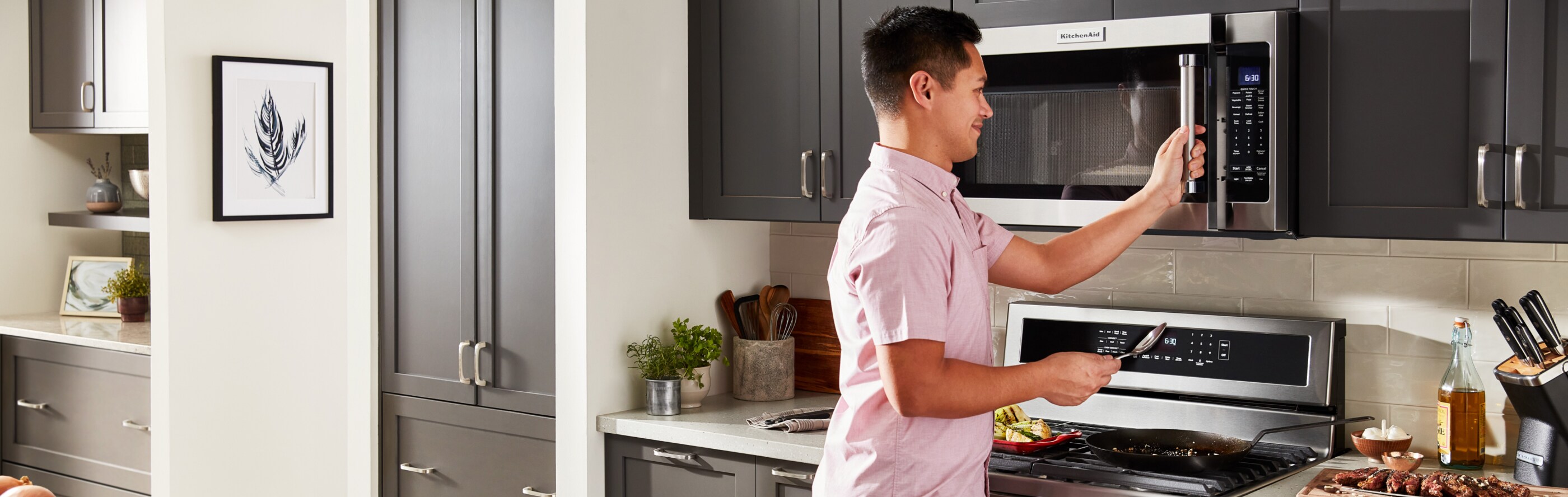 Person opening KitchenAid brand microwave