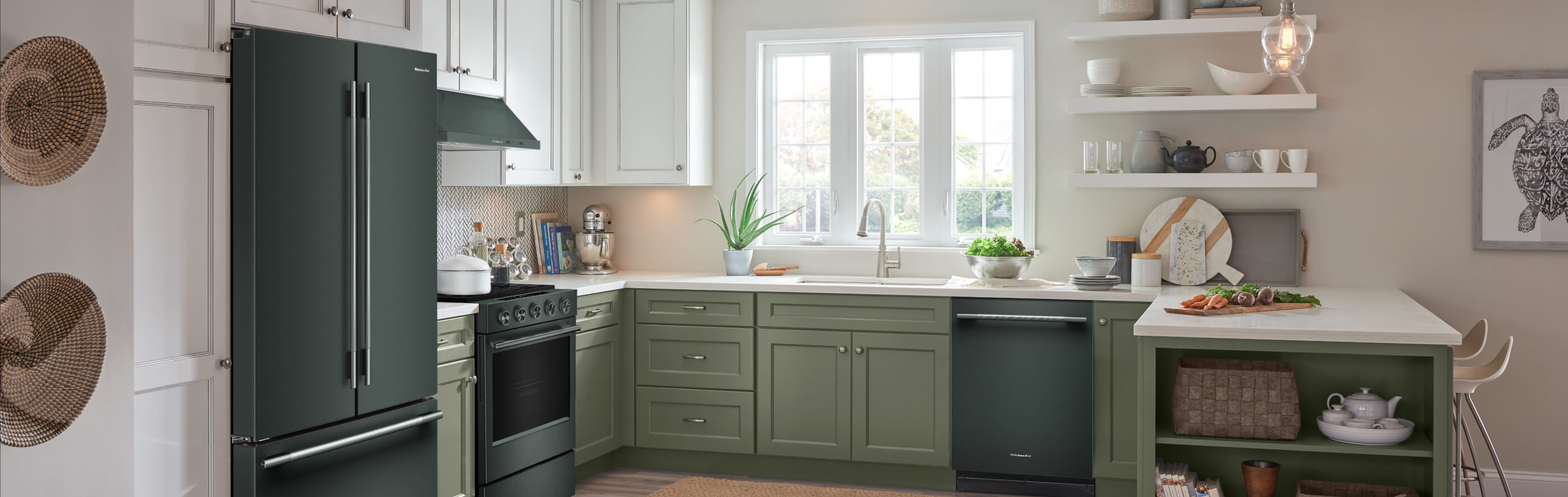 A kitchen with a suite of KitchenAid® appliances in the shade of Juniper