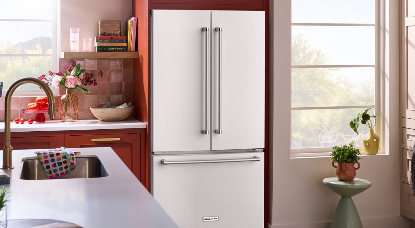A kitchen with a white KitchenAid® French door refrigerator