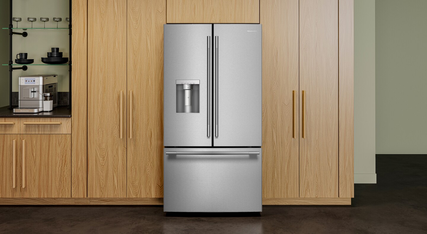 KitchenAid® stainless steel refrigerator and dishwasher in green kitchen