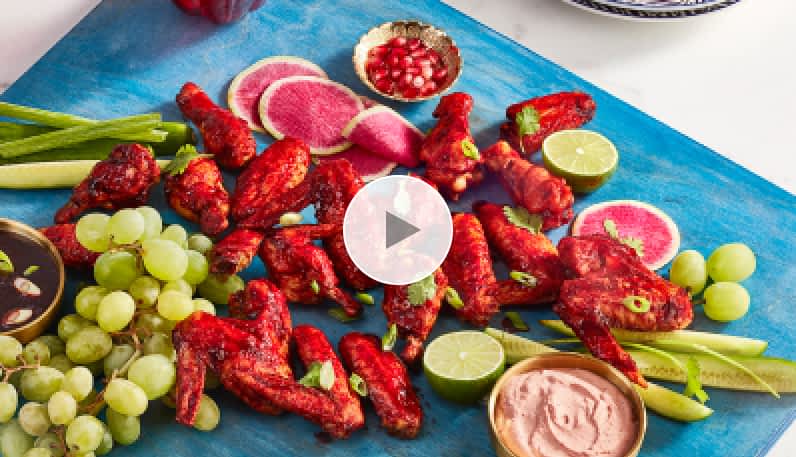 Chicken wings on a cutting board with a hibiscus glaze.