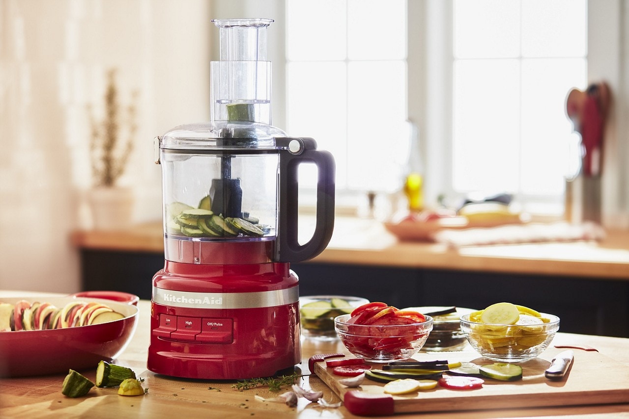 KitchenAid® Food Processor slicing zucchini on a counter. KitchenAid® Food Processor slicing zucchini on a counter.