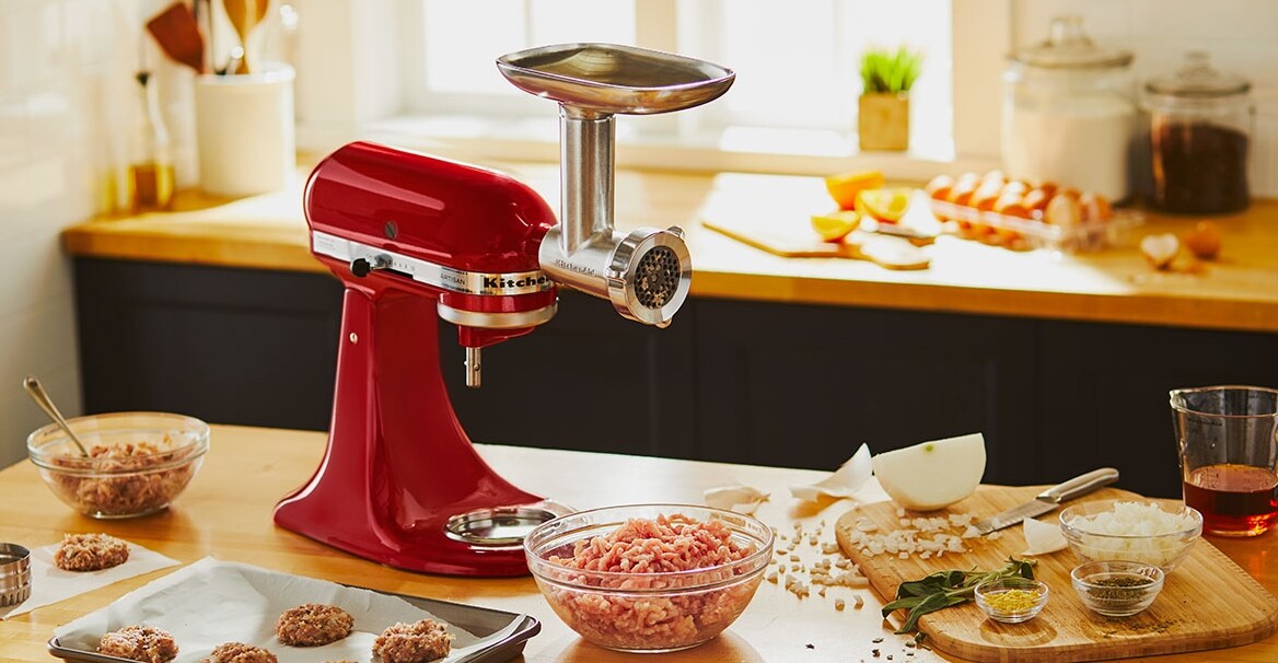A KitchenAid mixer with meat grinder attachment.