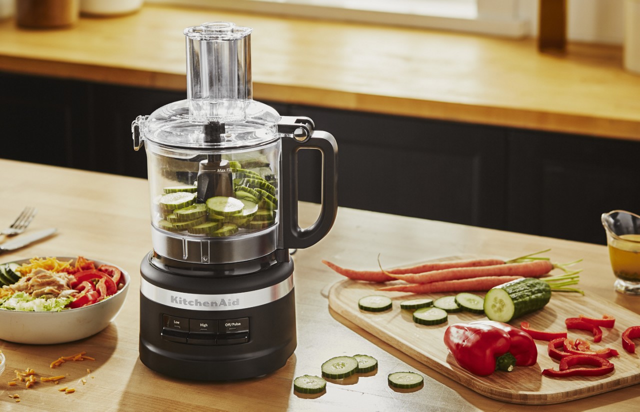 Drizzling oil into a KitchenAid® 5 Cup Food Chopper Drizzling oil into a KitchenAid® 5 Cup Food Chopper