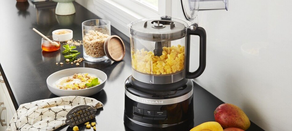 Black KitchenAid® Food Processor on counter surrounded by smoothie ingredients Black KitchenAid® Food Processor on counter surrounded by smoothie ingredients