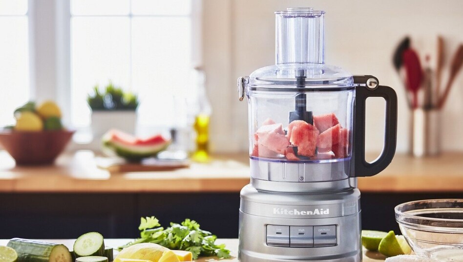 Bright kitchen featuring a silver KitchenAid® Food Processor with work bowl containing watermelon Bright kitchen featuring a silver KitchenAid® Food Processor with work bowl containing watermelon