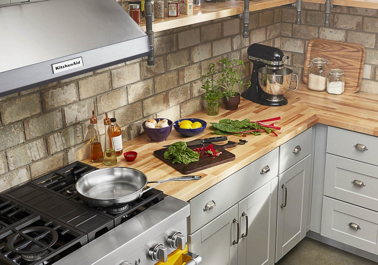 Chopped vegetables on a cutting board beside a KitchenAid® Commercial-Style Range Chopped vegetables on a cutting board beside a KitchenAid® Commercial-Style Range