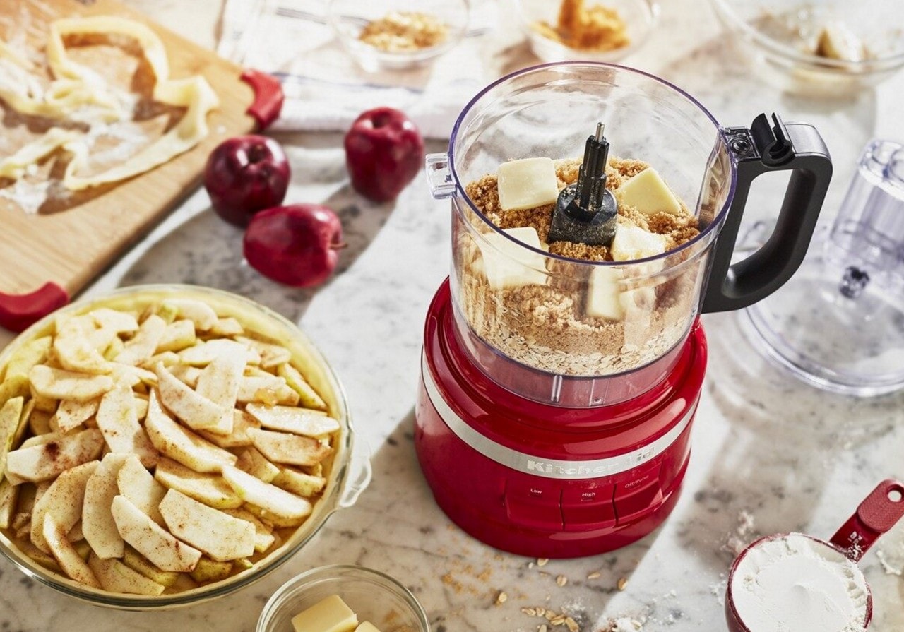 Red food processor filled with ingredients for pie crust Red food processor filled with ingredients for pie crust