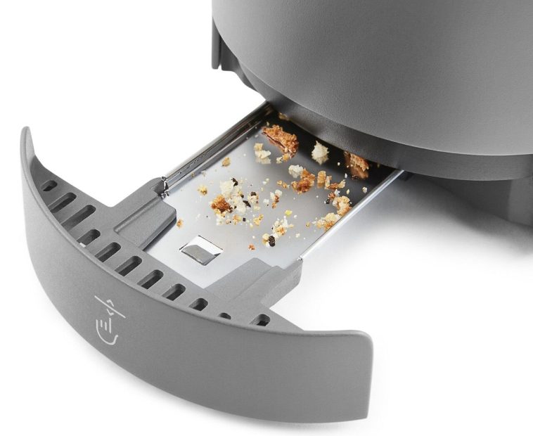 Dirty crumb tray pulled out from bottom of toaster Dirty crumb tray pulled out from bottom of toaster