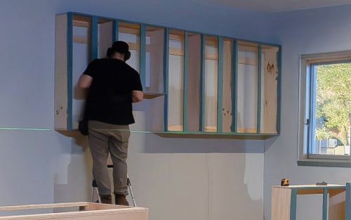 Person installing cabinetry
